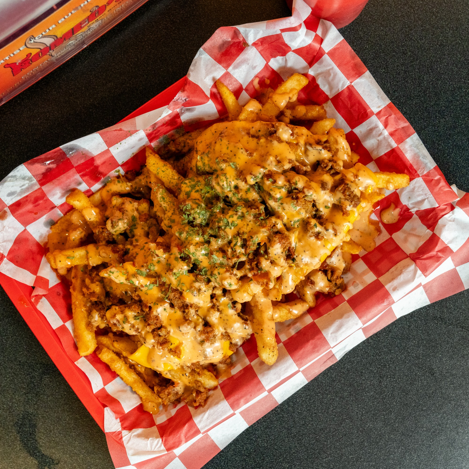 Romeo's Vegan Burgers' loaded fries with vegan cheese sauce, crumbled vegan meat, and parsley.